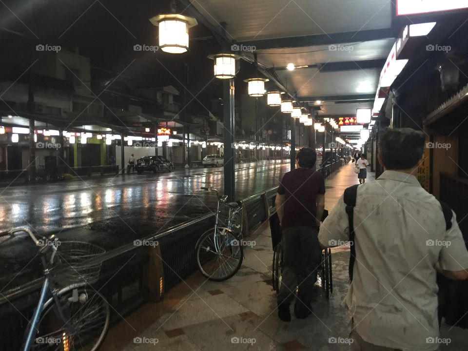 Be prepared for rain in June in Kyoto, like this couple strolling at night 
