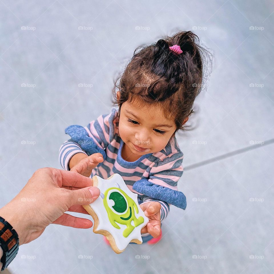 Mother handing cookie to toddler, mommy gives cookie to toddler, monsters Inc. cookies, extravagant desert