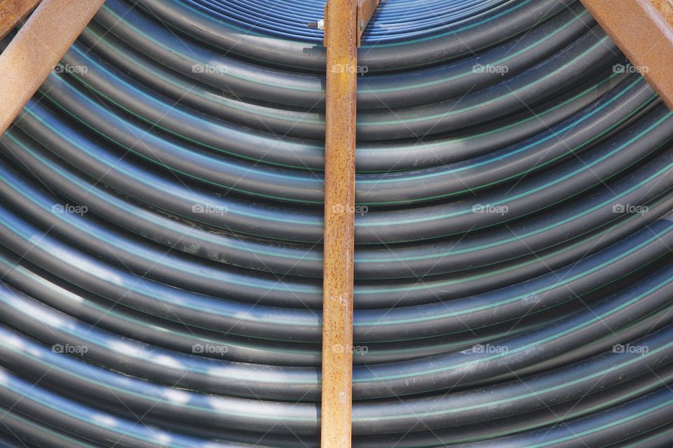 A closeup symmetrical  abstract of an underground tubing spool on a truck parked at a construction on the street in  Brooklyn, New York City.