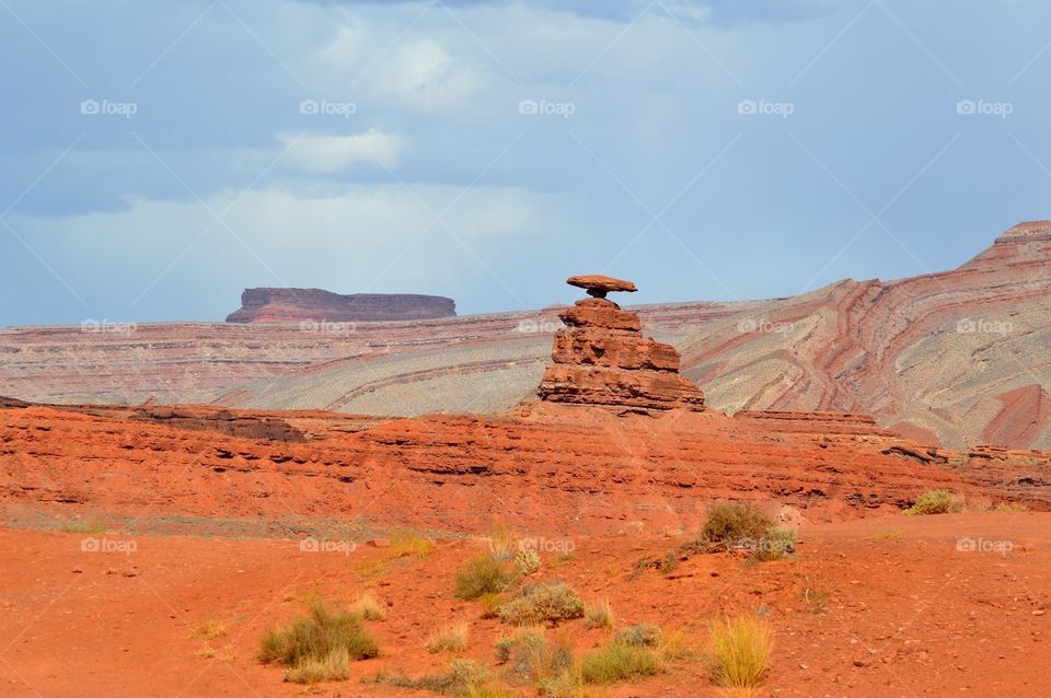 Geometric colors in the rock strata at Mexican Hat, Utah, make a colorful backdrop to the desert landscape.