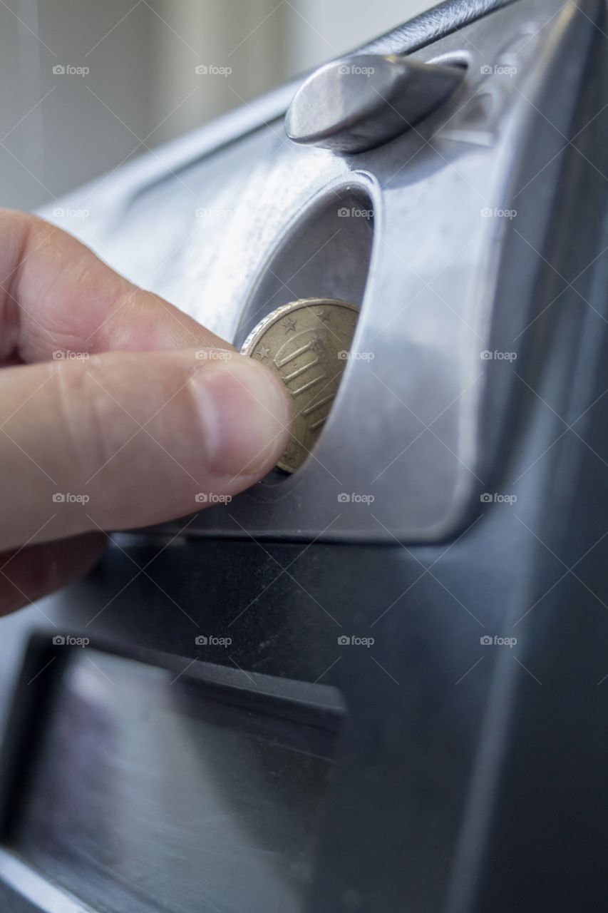 Inserting Coin in Pay Phone 