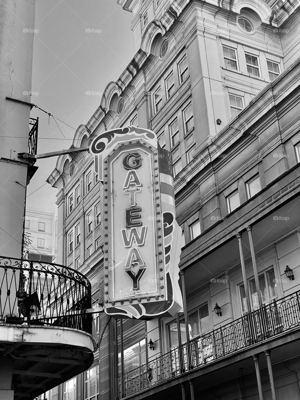 A neon sign on the side of a building in a city