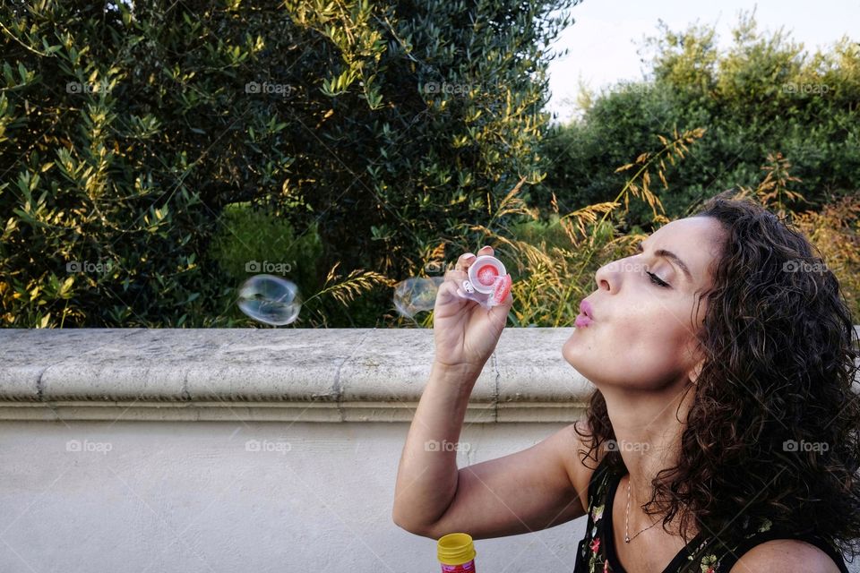 Girl enjoys making soap bubbles