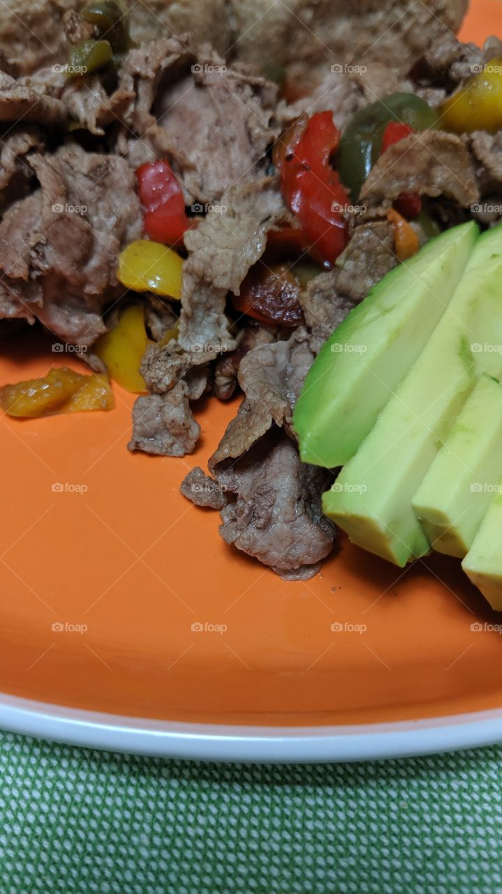 beef with peppers and a side of avocado