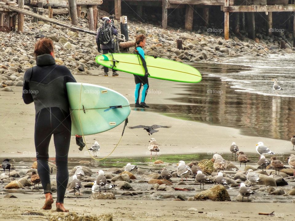 Surfers on the beach in the town of Pacifica on the San Francisco Peninsula