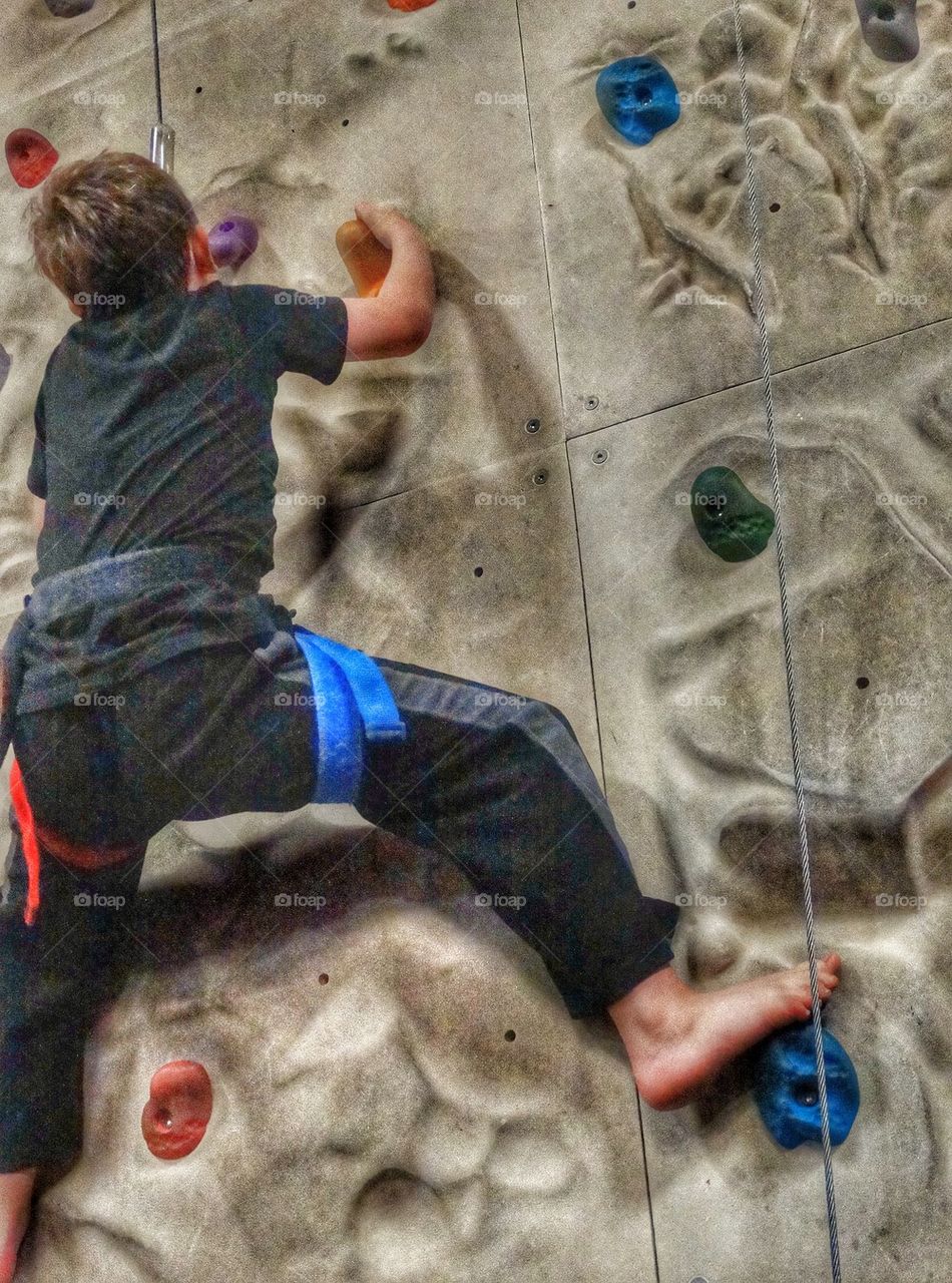 Boy Climbing Rock Wall