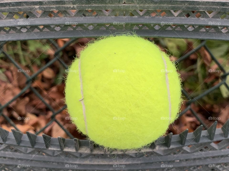 One tennis ball stuck in the sweeper equipment.