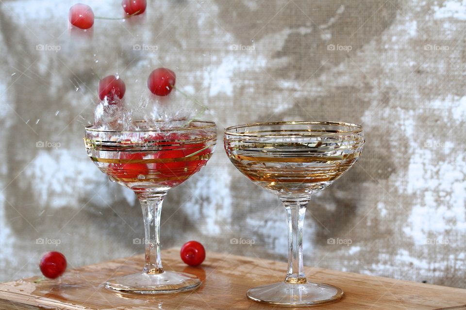 red cherry and two champagne glasses