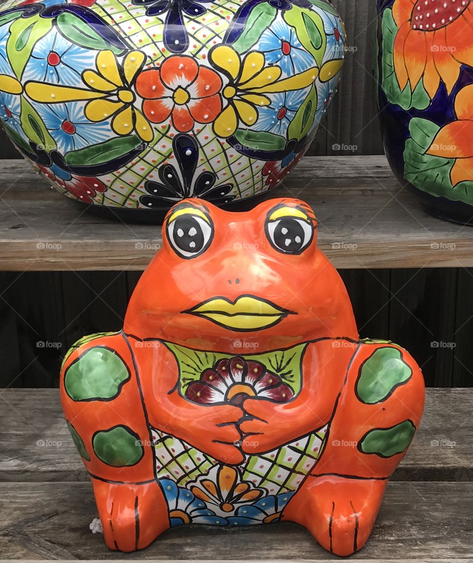 Orange painted ceramic frog. With lips