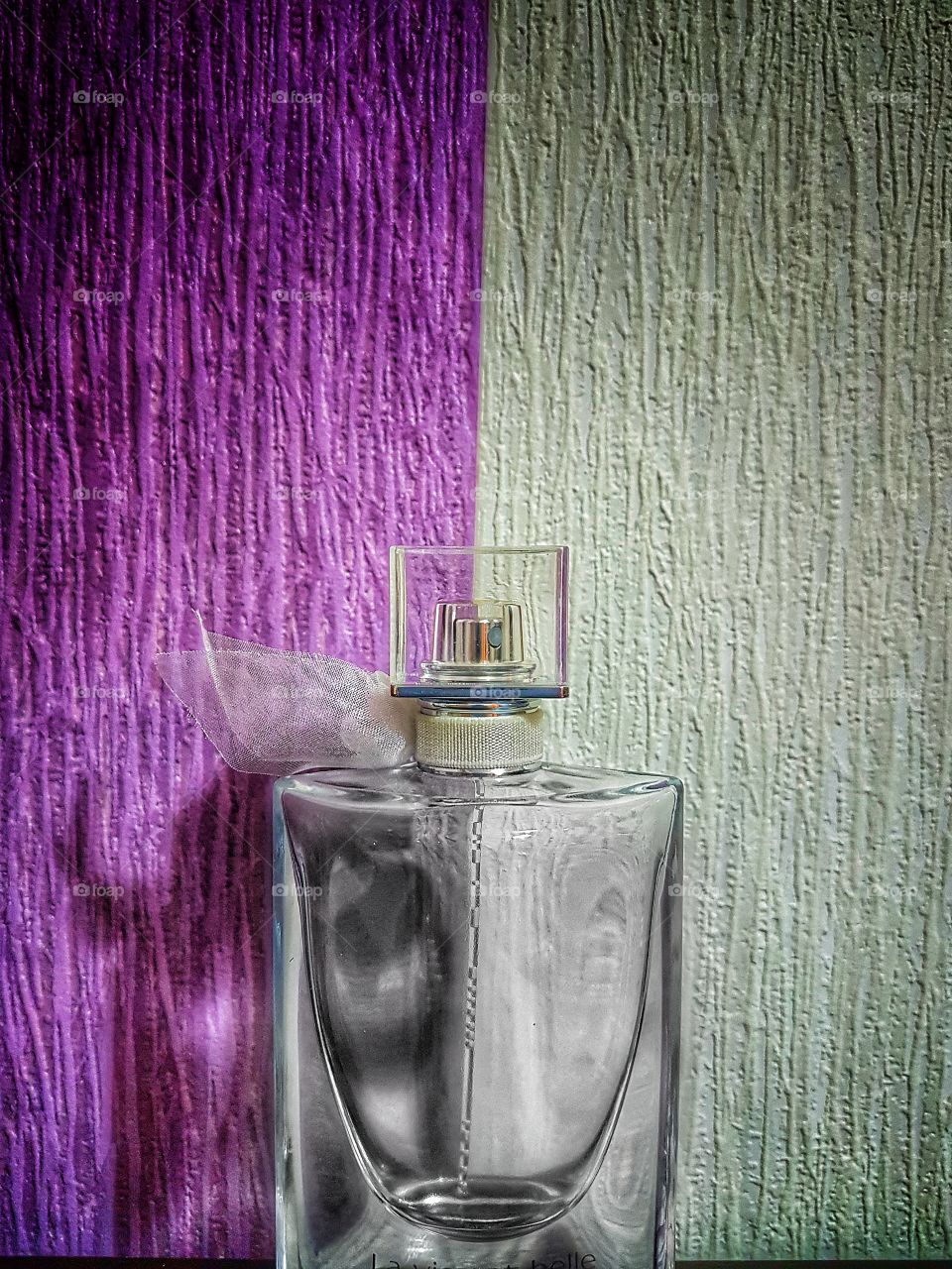 Perfume bottle beside wall