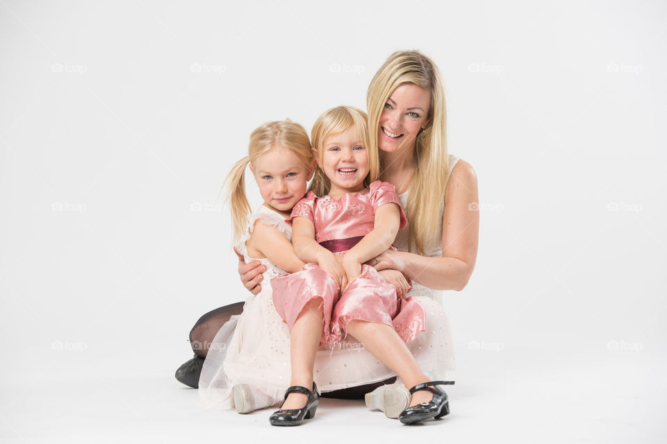 Happy family, mother with her two daughters of 6 and four years old.