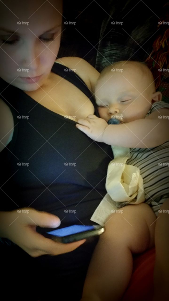 Mother sitting with child using Smartphone