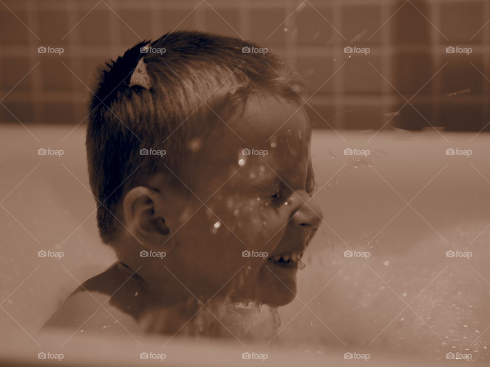Close-up of boy in bathtub