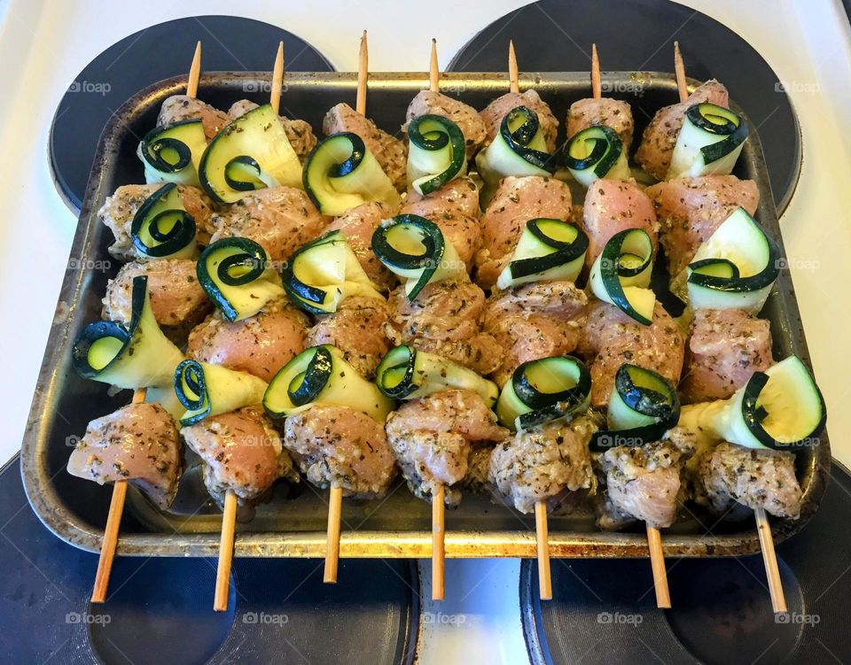 Prepared ingredients for the delicious meal, chicken with zucchini on wooden skewers