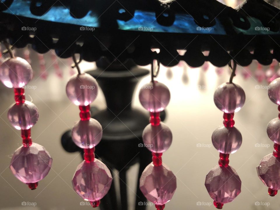 Beads hanging off of a lamp 