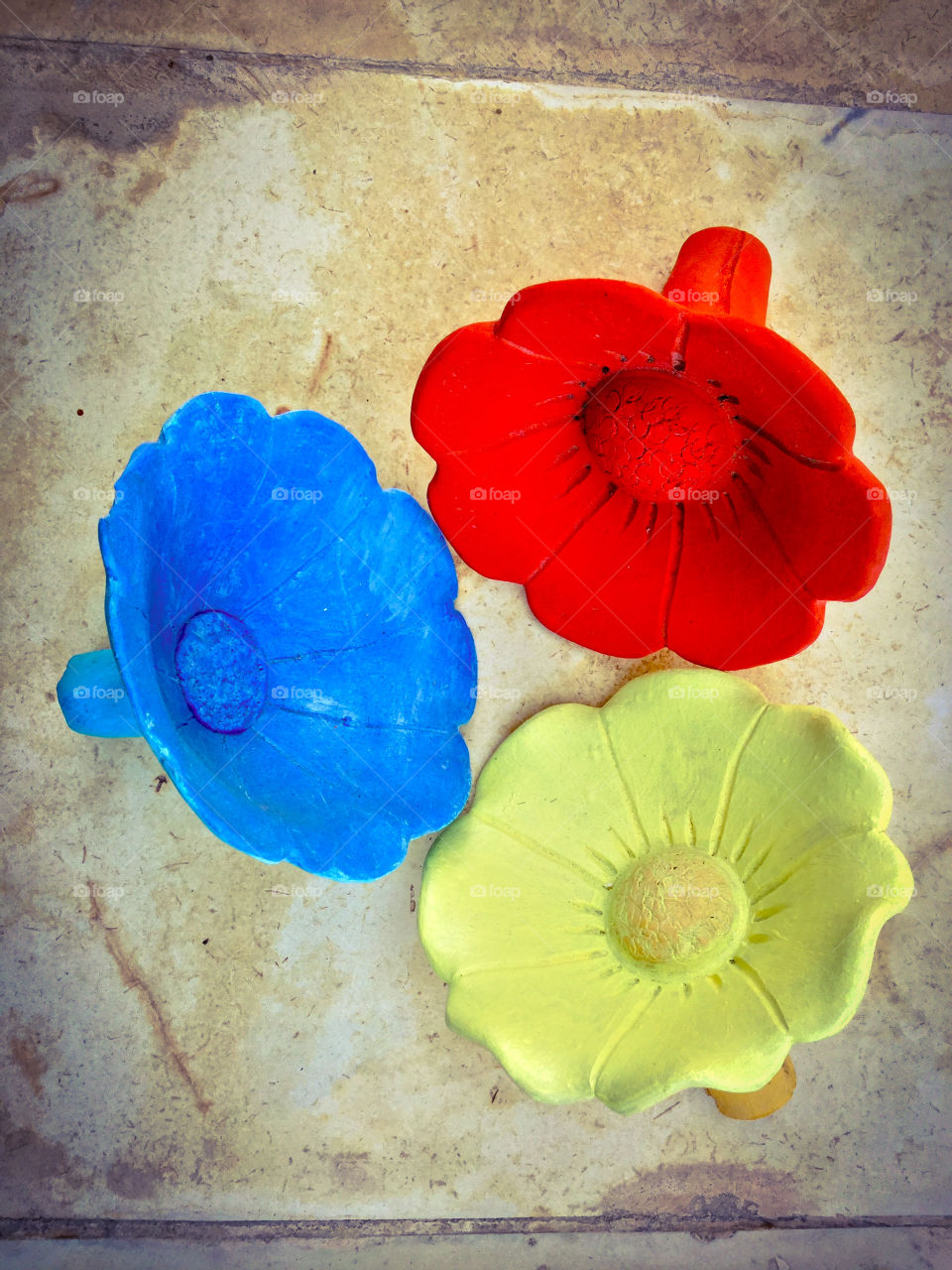 Three homemade flowers. Blue yellow red . 