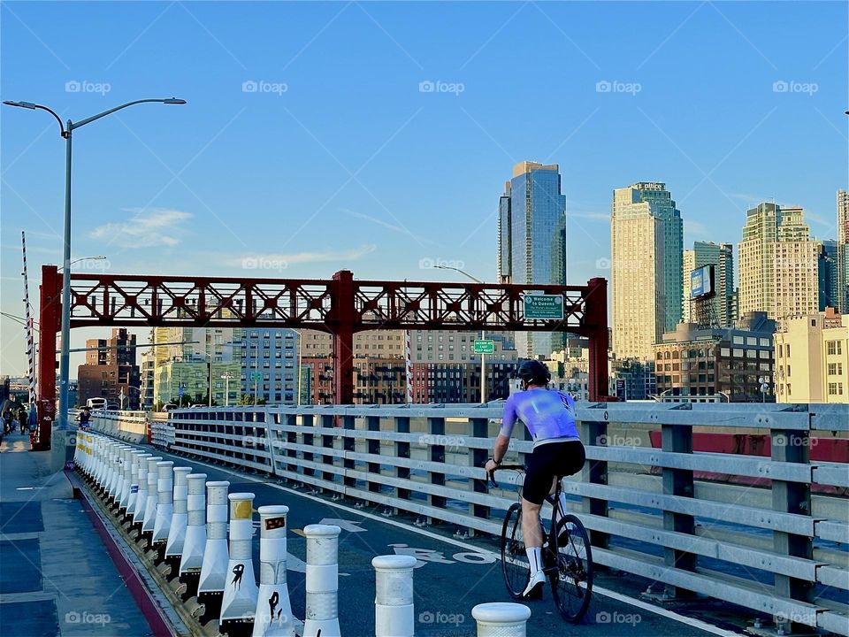 These are the streamlined pedestrian and bicycle lanes of the “Pulaski Bridge” at “Newtown Creek” that connects “Greenpoint”, Brooklyn to LIC, Queens in the direction we are currently headed. 2024. Hypnotic Productions