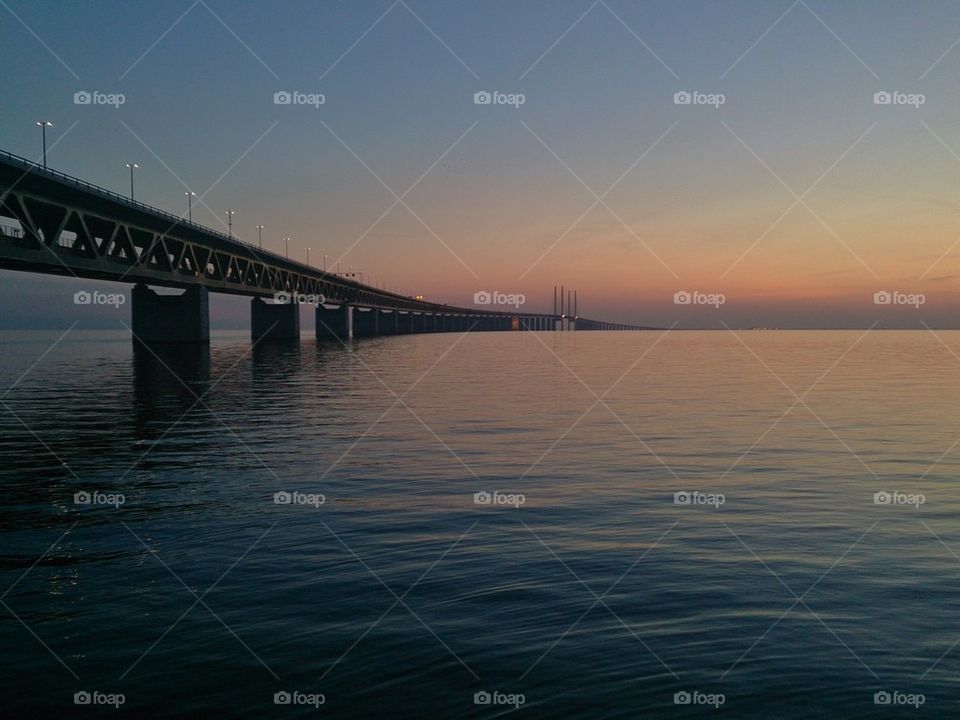 Bridge over sea during sunset