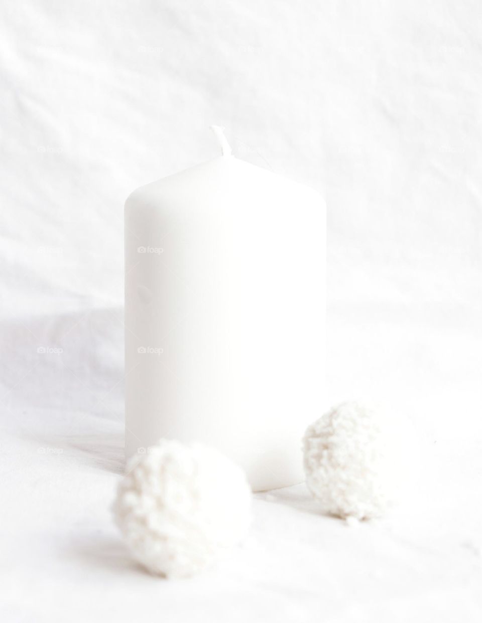 A white candle with coconut candies