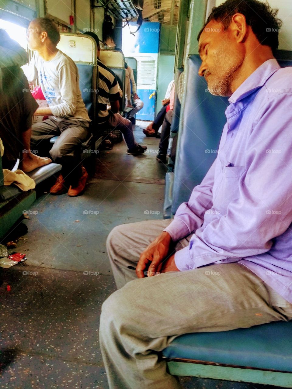 man sleeping while travelling in the train