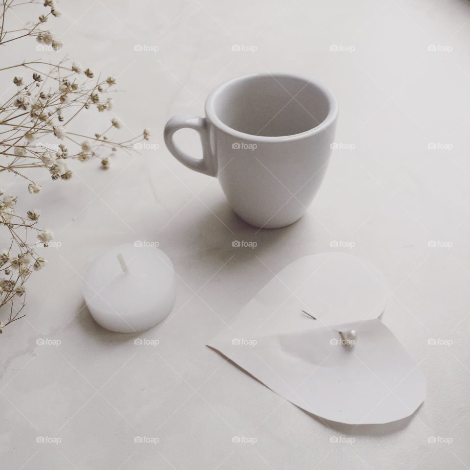 White on white. Heart, candle, a cup of coffee