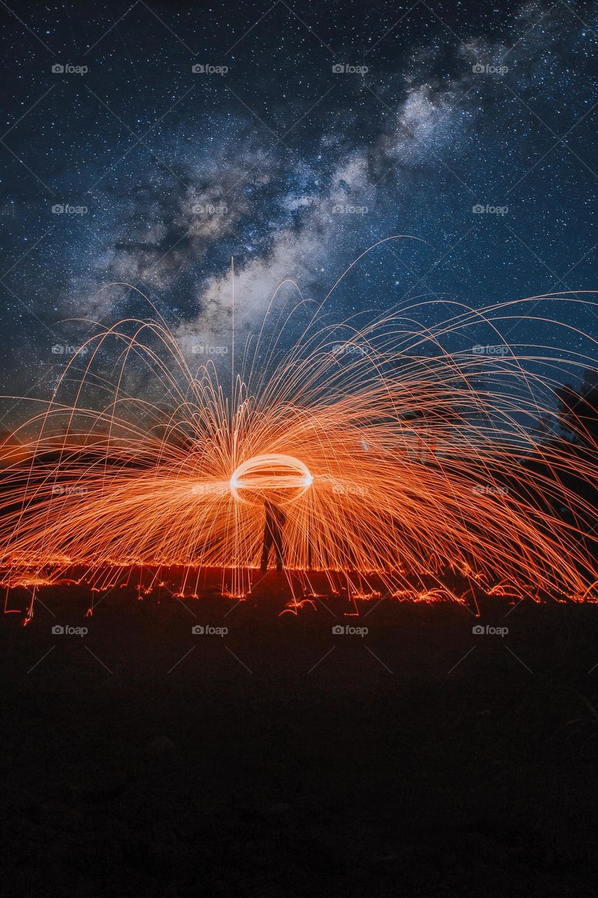 man spinning steelwool in long exposure
