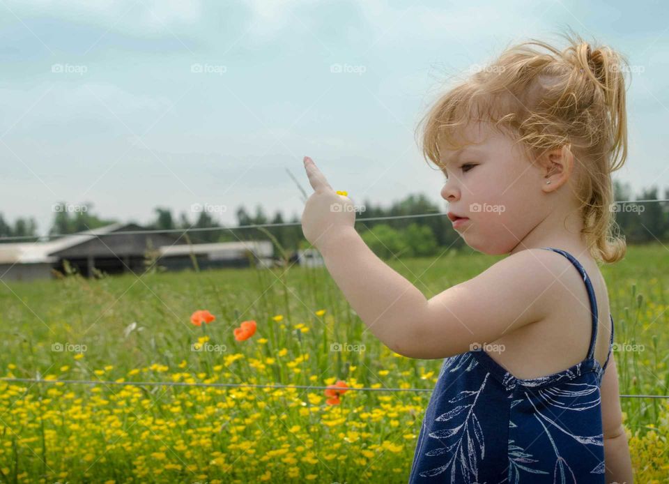 Close-up of a girl holding yellow flower