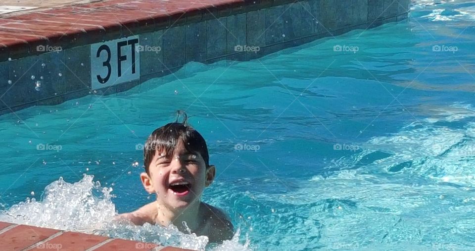 Boy enjoying in swimming pool