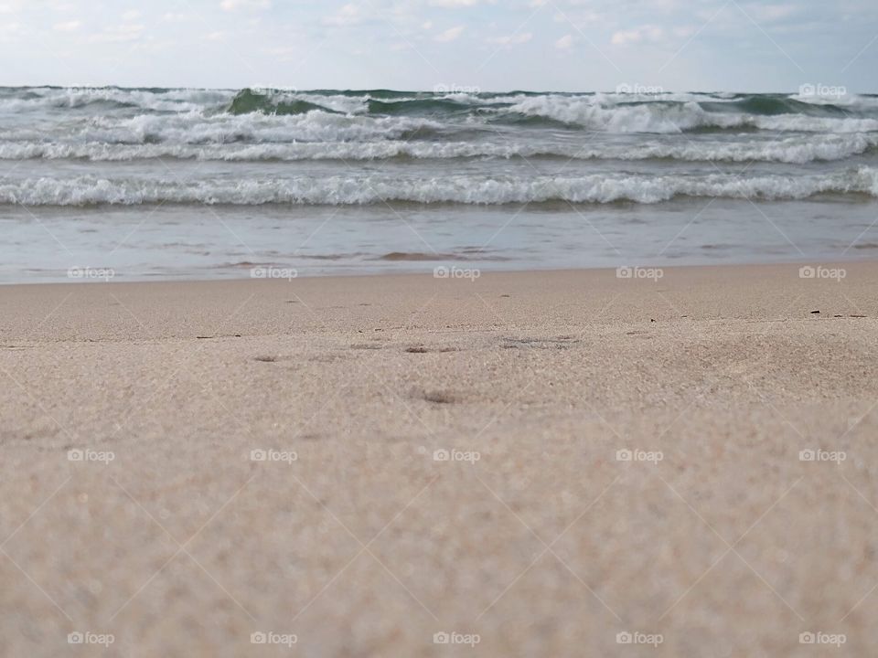 Unfiltered beautiful closeup of sand and waves on a beach