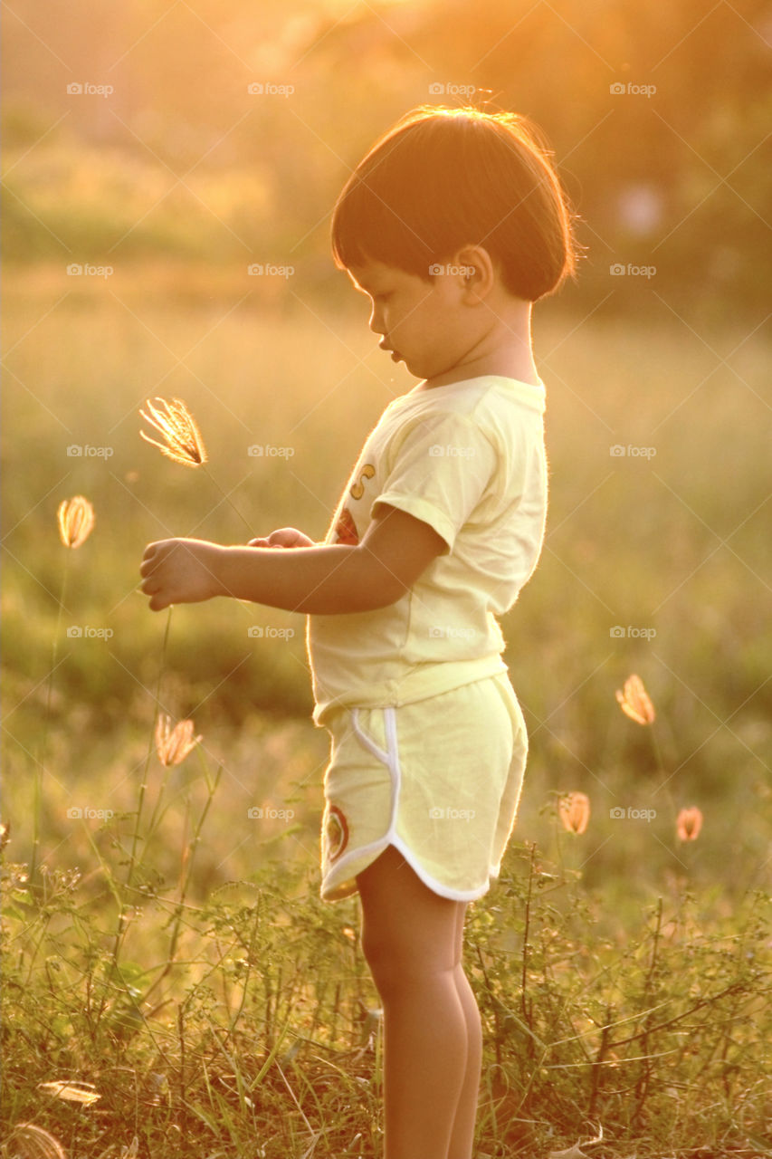 Boy during golden hour. simple pleasure of life as kid