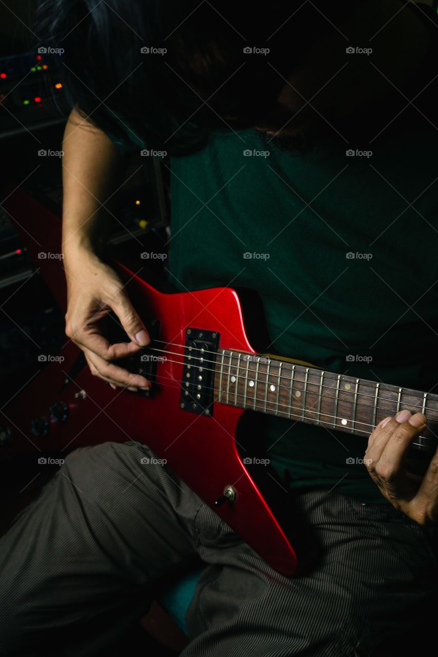 musician playing with red guitar