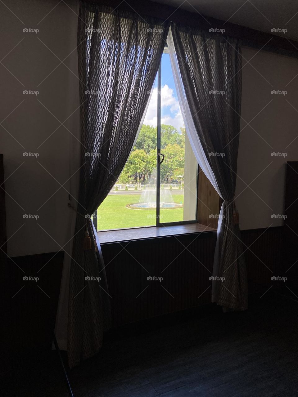 Fountain view through window of independence palace 