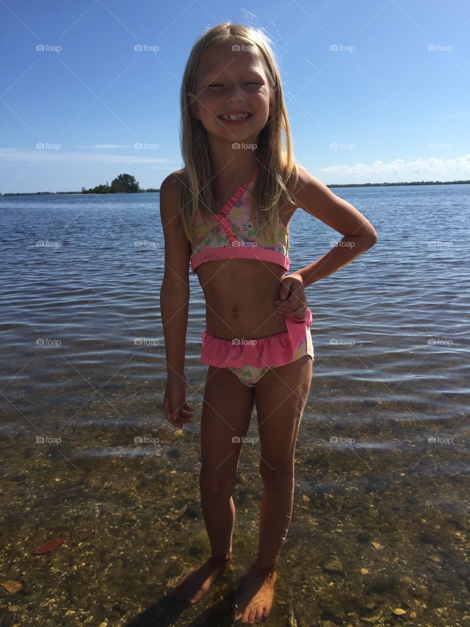 Little girl posing in the ocean 