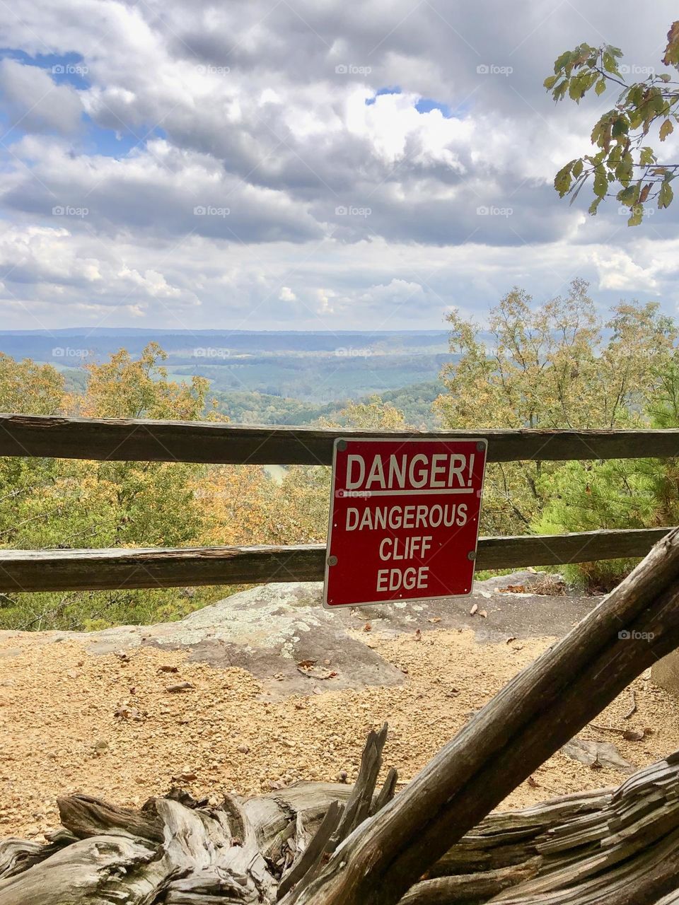 Warning sign at the edge of a scenic cliff in the foothills of the Appalachian Mountains, USA