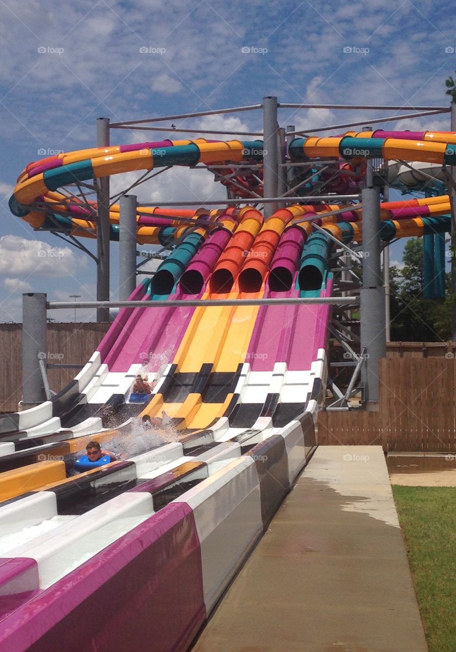 Slip and slide . Boy on Water park slide at hurricane harbor