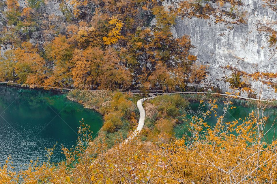 Wooden pathway across lake at Plitvice lakes national park in Croatia in autumn