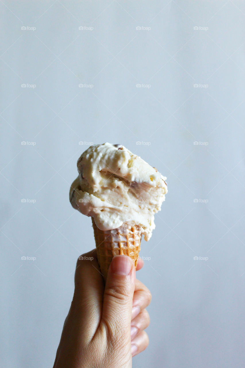 Woman hand holding ice cream cone