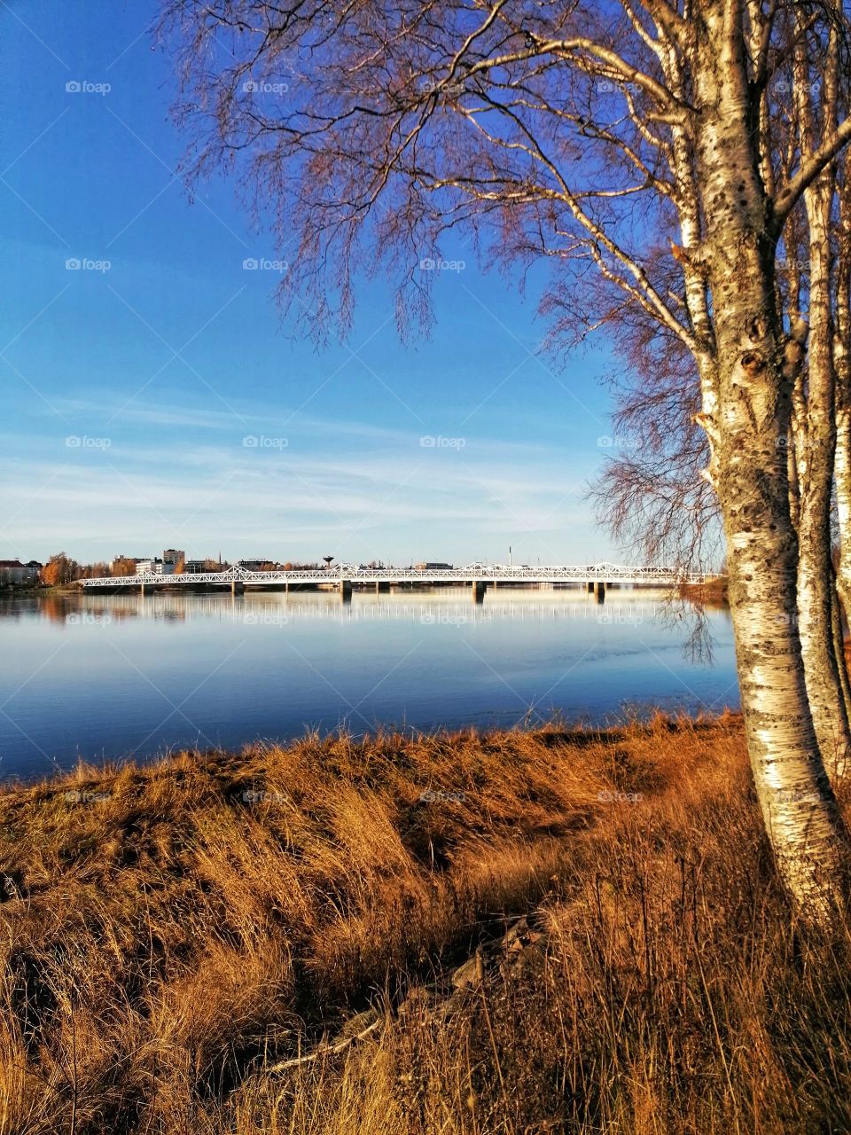 Great view on the Tornio River, Lapland, Finland in autumn. The Finnish-Swedish border is shown on the left.