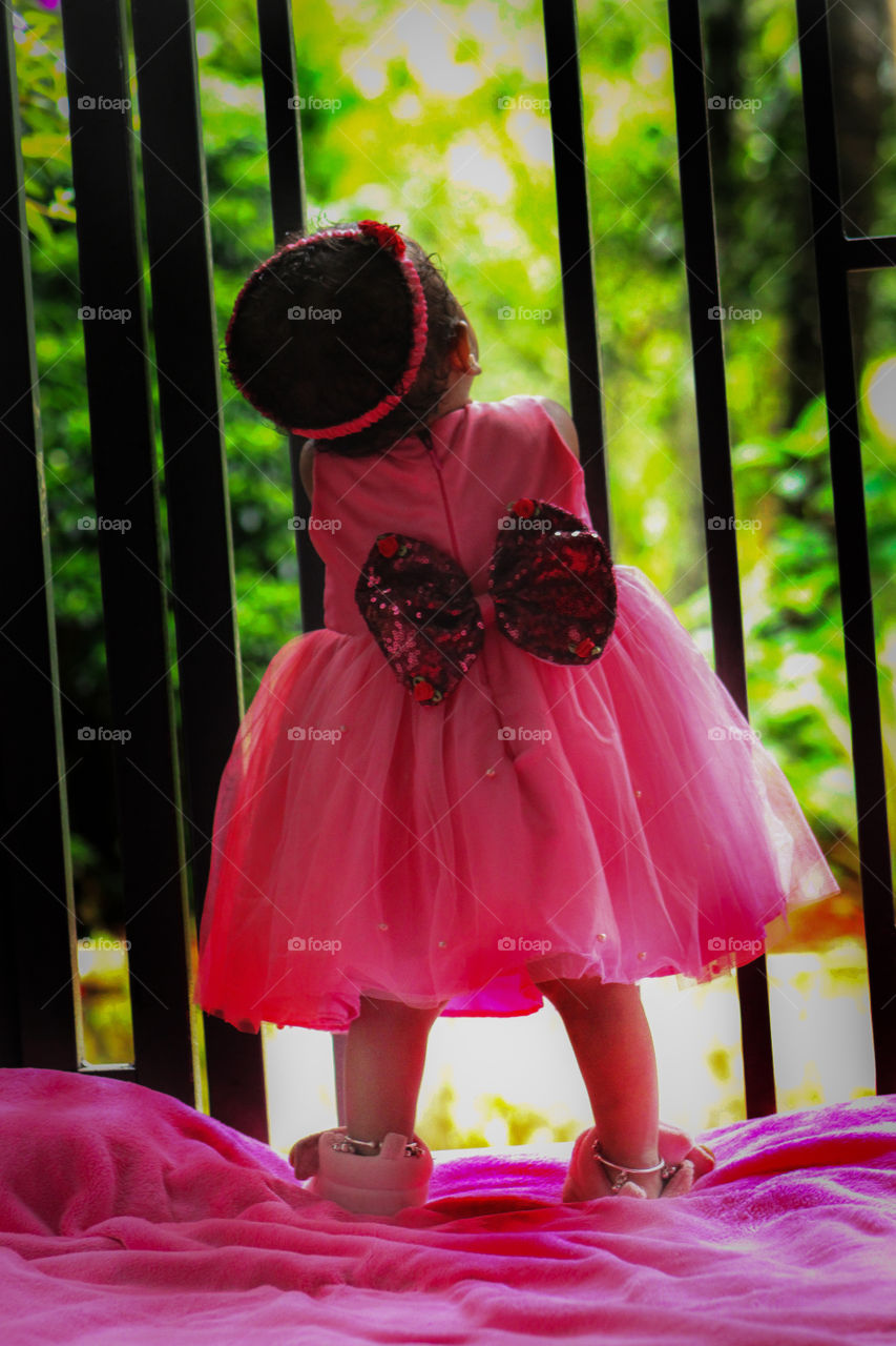 pink colour. Cute baby girl wearing pink colour dress photo