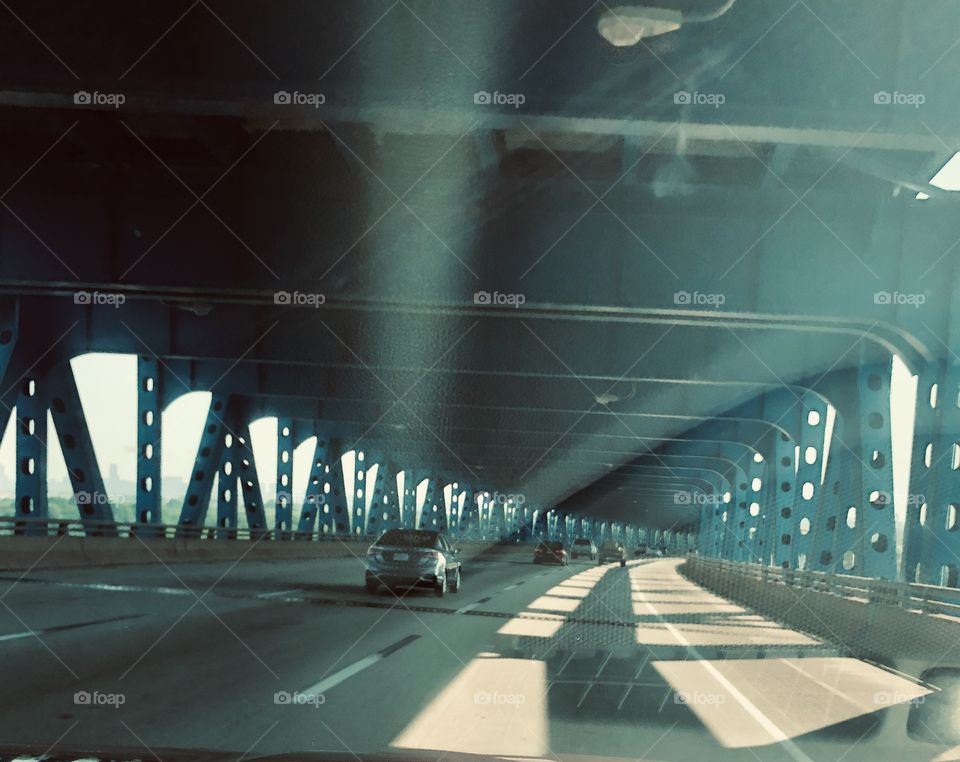 Sun rays between columns on a covered bridge