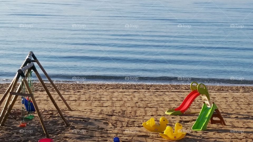 Swing and slide on the beach