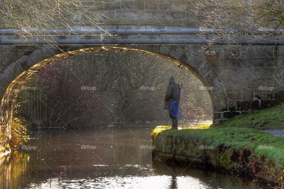 A moment alone. Lone fisherman contemplating his spot