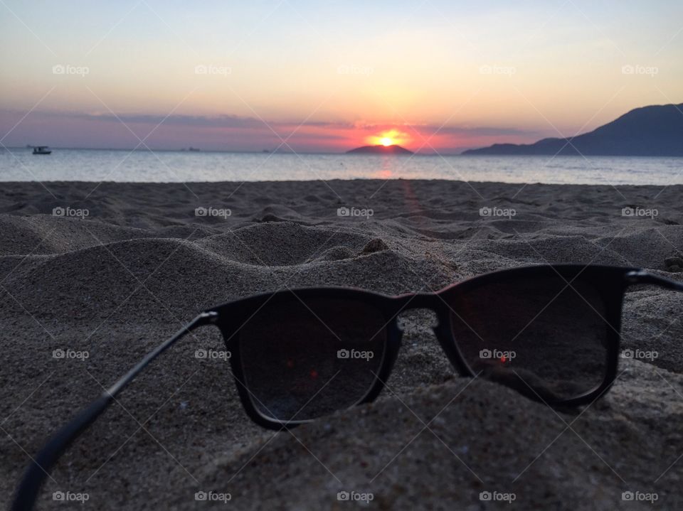 The sunglasses, the sand and the sunset