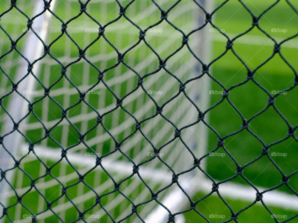 Close-up view soccer field perimeter netting