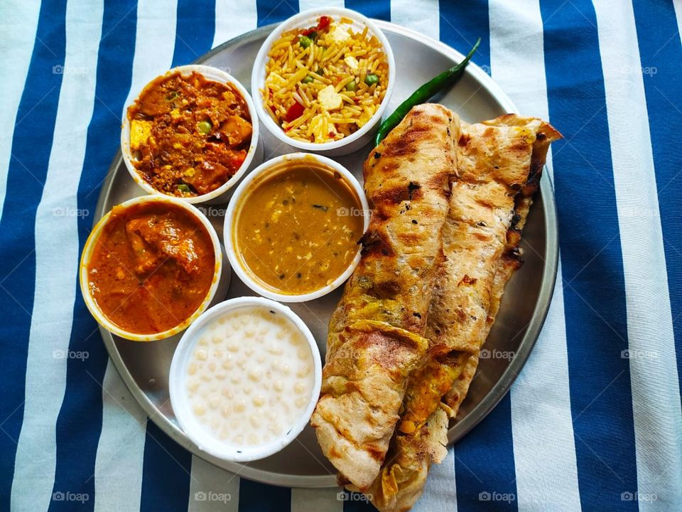 Thali (meaning "plate") is a round platter used to serve food in the Indian subcontinent and Southeast Asia. Thali is also used to refer to an Indian-style meal made up of a selection of various dishes which are served on a platter.