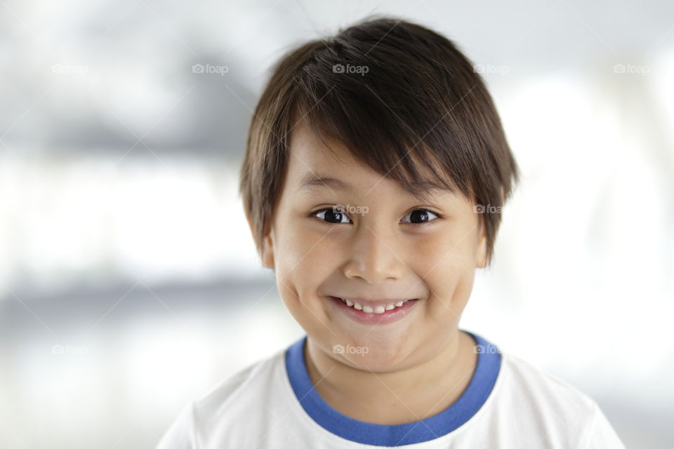 portrait of smiling happy eurasian boy
