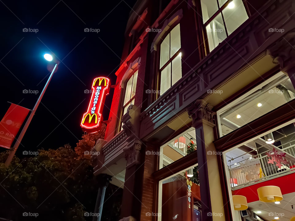 Urban street side sidewalk view of the infamous fast food chain McDonald's located in the historic preserved 1889 Dullnig building.