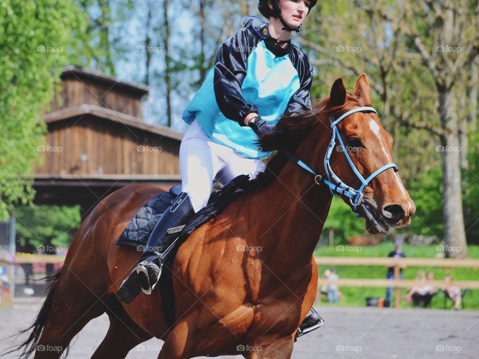 Woman riding her horse