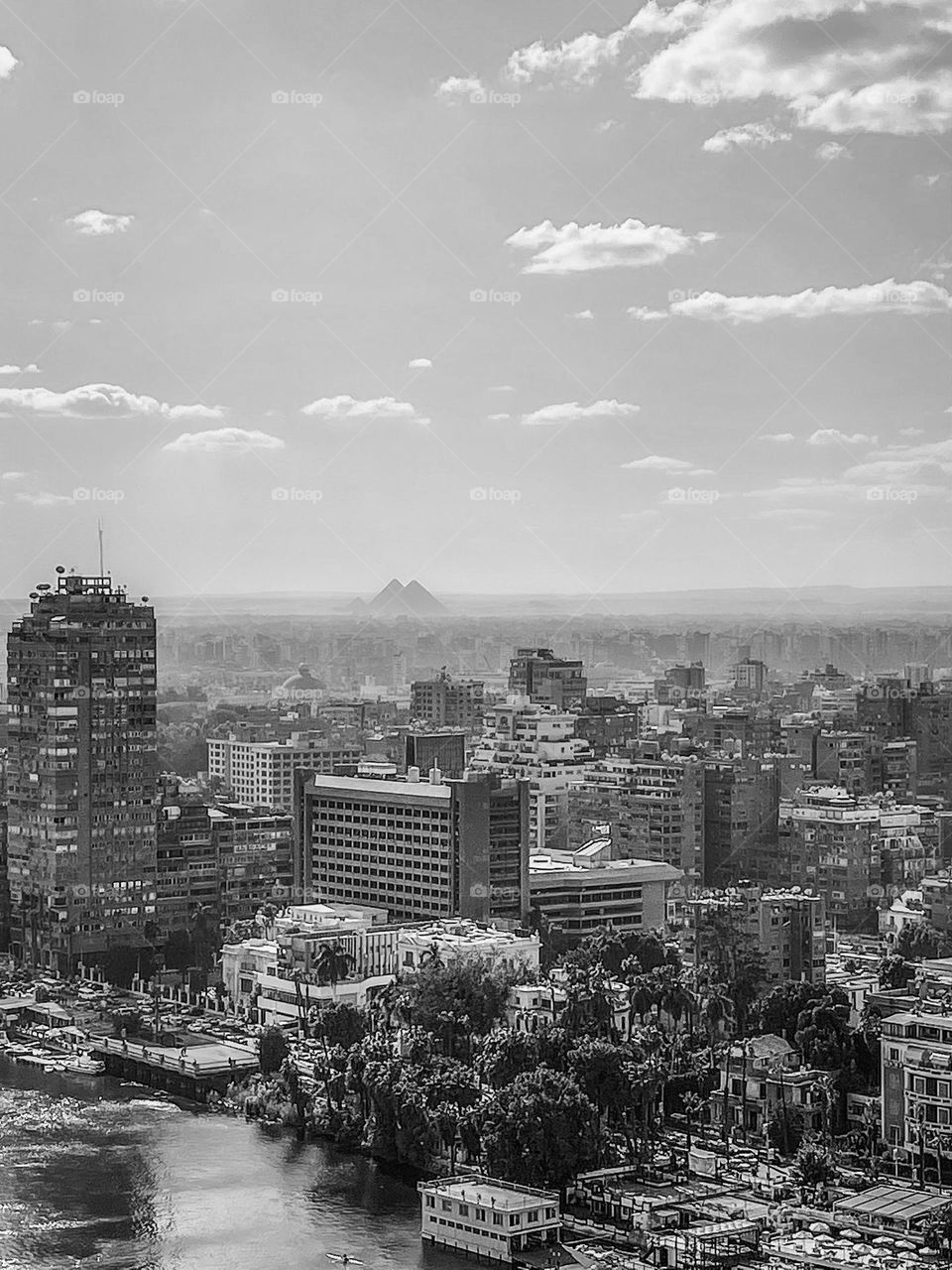 Cairo’s timeless skyline, along the river Nile, with the Giza pyramids in the background. 