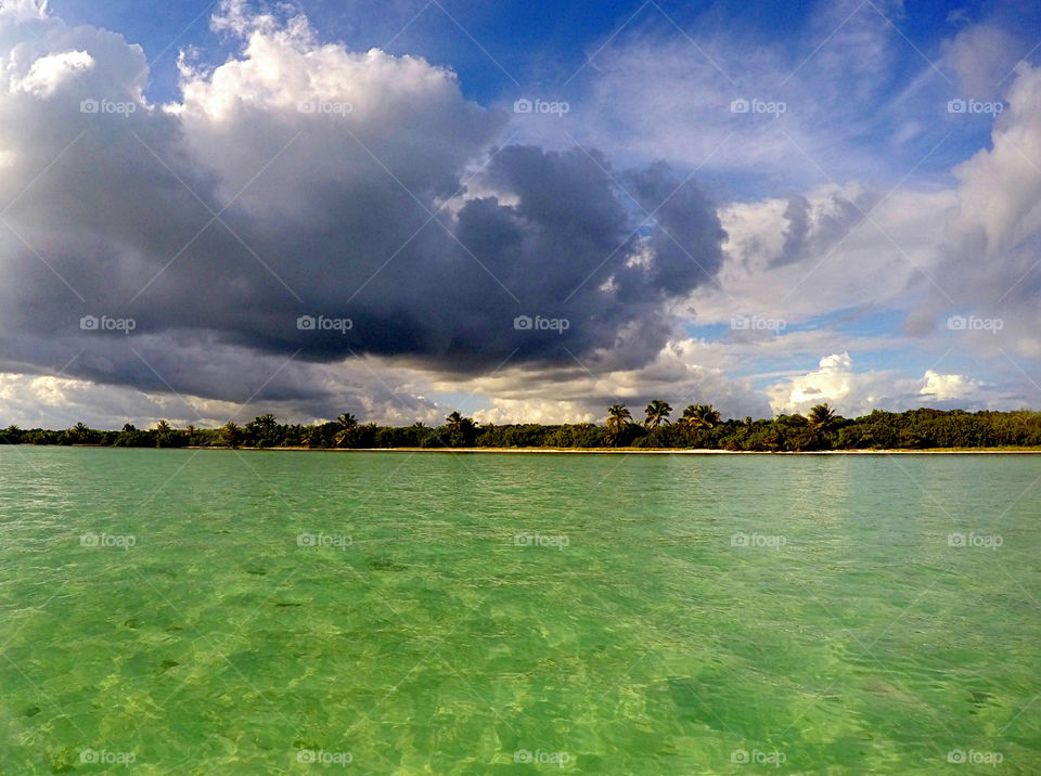 storm cloud over green sea water